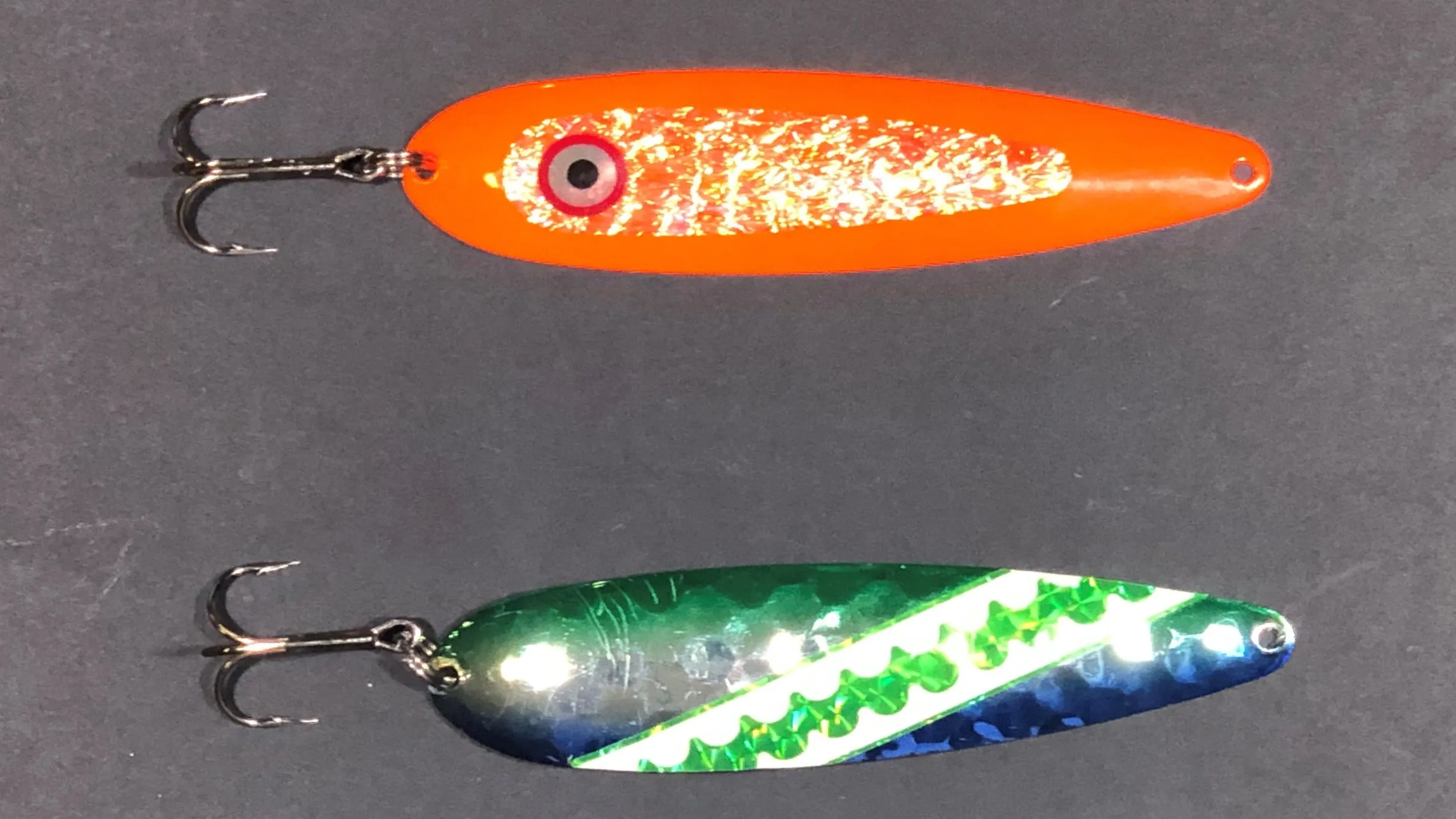 an orange crush and blue dolphin trolling spoon